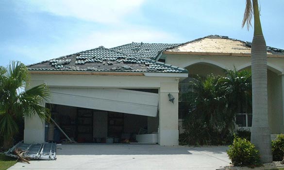 Hurricane damaged garage door before new garage door installation